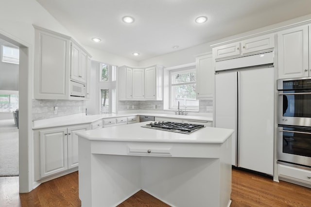 5541 70th St, Edina, MN 55439 - kitchen with stainless steel appliances, white cabinets, backsplash, light countertops, and recessed lighting