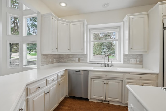5541 70th St, Edina, MN 55439 - kitchen featuring stainless steel dishwasher, a sink, white cabinets, tasteful backsplash, and recessed lighting