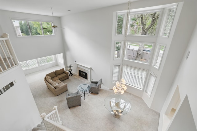 5541 70th St, Edina, MN 55439 - living area with a high ceiling, carpet floors, and a fireplace with flush hearth