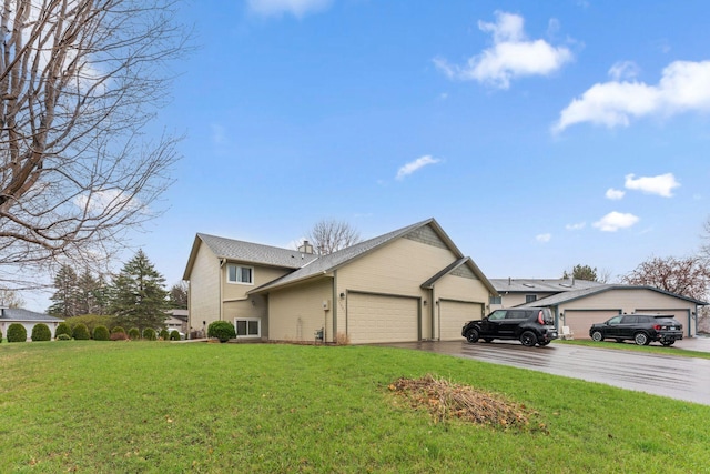 view of front of home featuring a garage, brick siding, a chimney, and a front yard