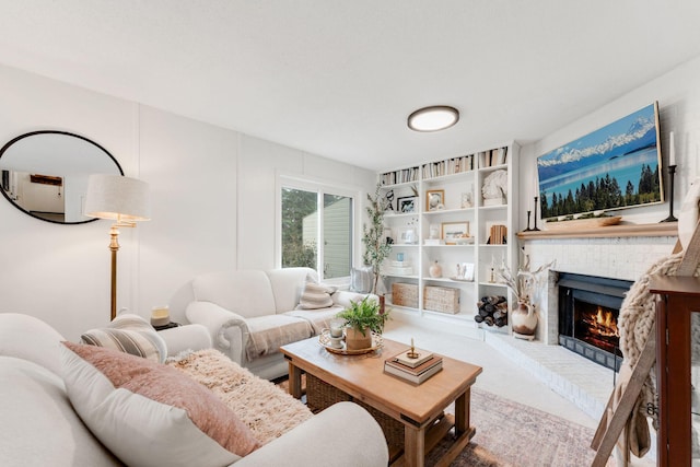 living room with carpet flooring and a brick fireplace