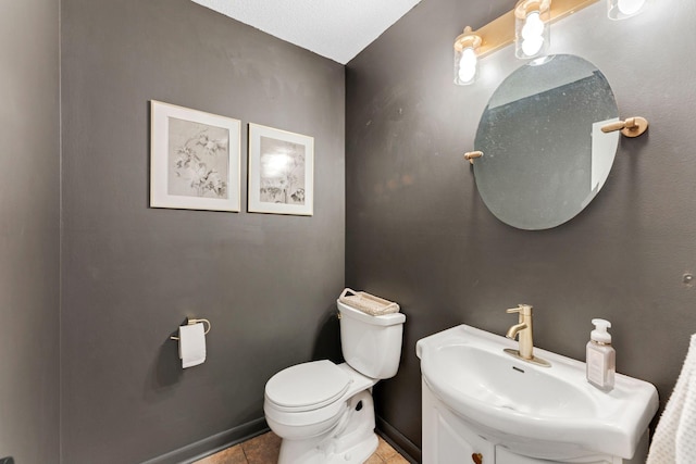 half bath featuring tile patterned floors, vanity, and toilet