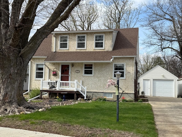 bungalow-style house featuring a front lawn, a shingled roof, an outdoor structure, a detached garage, and stucco siding