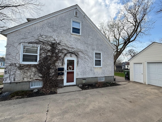 view of front of house with an outdoor structure and stucco siding