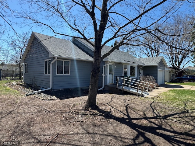 ranch-style house with a shingled roof and an attached garage