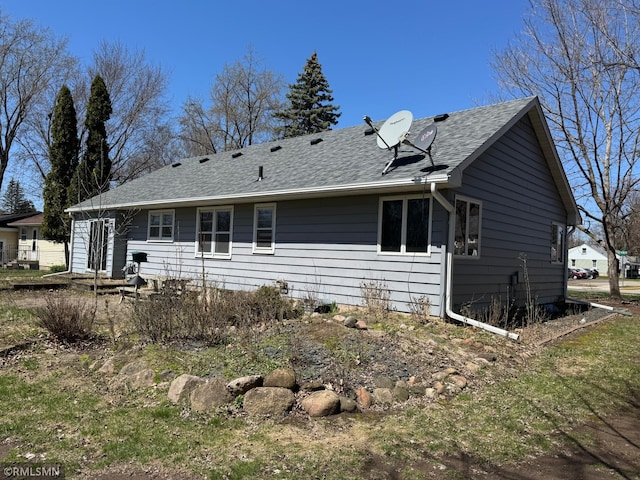 back of property with roof with shingles
