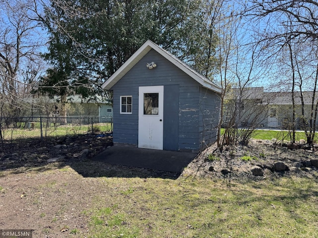 view of outbuilding with fence and an outdoor structure