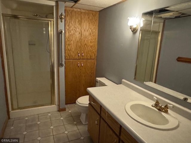 full bathroom featuring a stall shower, toilet, and vanity