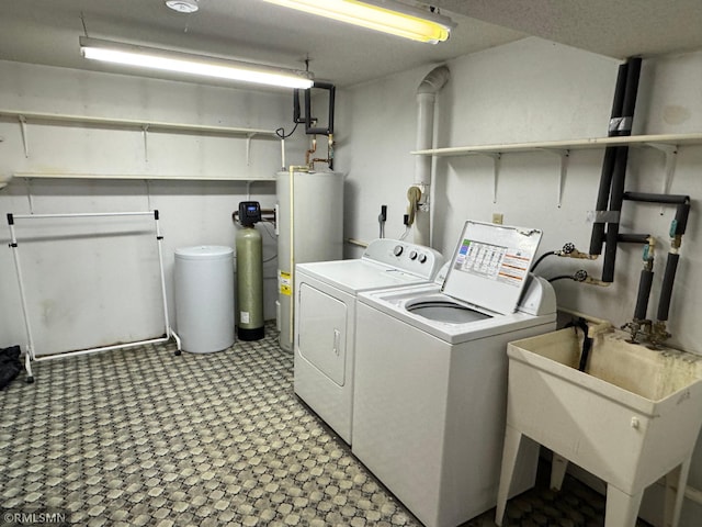 laundry room with gas water heater, a sink, independent washer and dryer, laundry area, and light floors