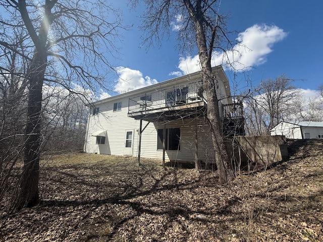 rear view of property with a wooden deck