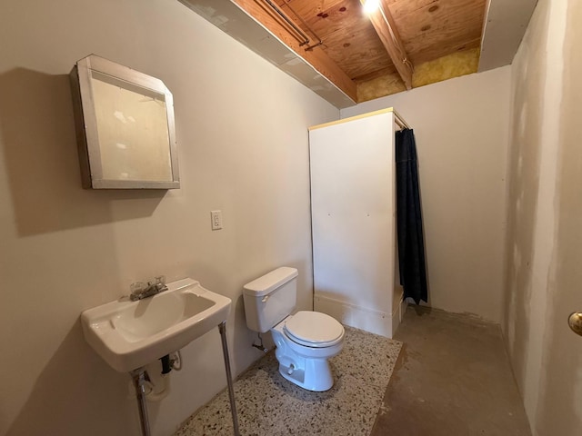 bathroom with toilet, a sink, concrete flooring, and wooden ceiling