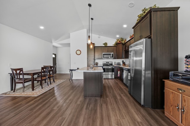 kitchen featuring light countertops, stainless steel appliances, dark wood finished floors, and lofted ceiling