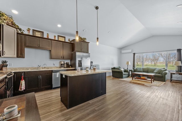 kitchen with a kitchen island, dark brown cabinets, light wood-style floors, vaulted ceiling, and stainless steel appliances