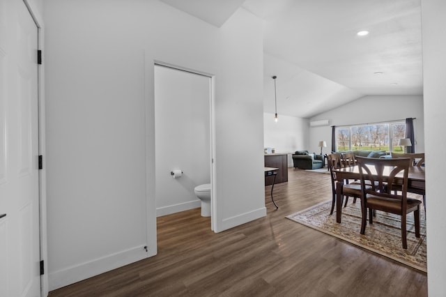 dining area featuring recessed lighting, baseboards, wood finished floors, vaulted ceiling, and a wall mounted AC