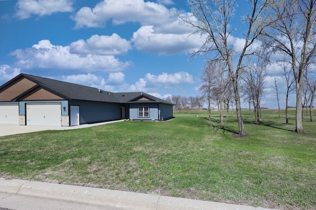 view of front of property with a garage, driveway, and a front lawn