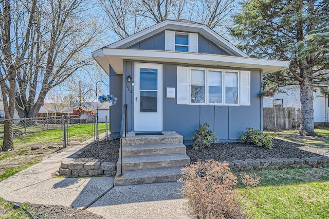 view of front of home with board and batten siding and fence