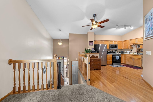 26294 3rd St W, Zimmerman, MN 55398 - kitchen with rail lighting, a ceiling fan, light wood-style flooring, appliances with stainless steel finishes, and lofted ceiling