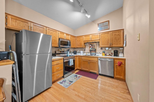 26294 3rd St W, Zimmerman, MN 55398 - kitchen featuring light wood-style flooring, appliances with stainless steel finishes, light countertops, track lighting, and high vaulted ceiling