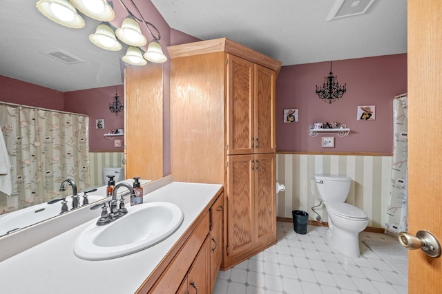 26294 3rd St W, Zimmerman, MN 55398 - full bathroom featuring toilet, visible vents, wainscoting, and tile patterned floors