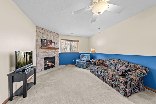 26294 3rd St W, Zimmerman, MN 55398 - carpeted living room featuring a ceiling fan, a stone fireplace, and baseboards
