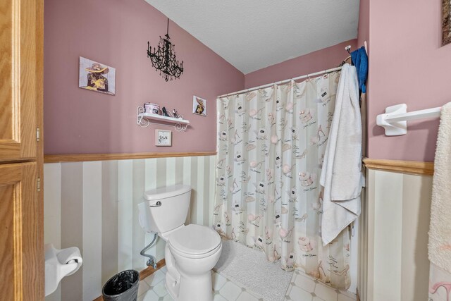 26294 3rd St W, Zimmerman, MN 55398 - full bathroom with toilet, wainscoting, a textured ceiling, and curtained shower