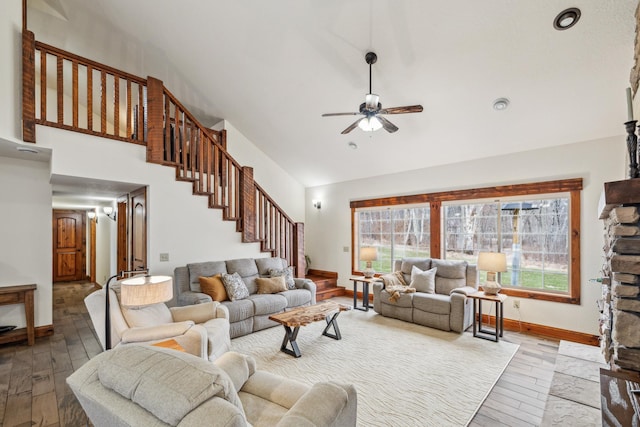 living area featuring a ceiling fan, high vaulted ceiling, stairs, and wood-type flooring