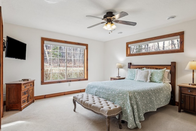 bedroom with baseboards, a ceiling fan, and light colored carpet