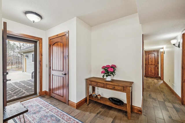 foyer with wood finished floors and baseboards