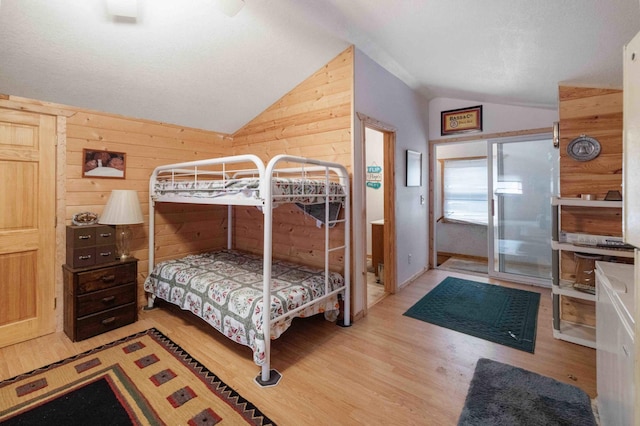 34470 Spruce Ln, Pequot Lakes, MN 56472 - bedroom with vaulted ceiling, wood finished floors, and wooden walls