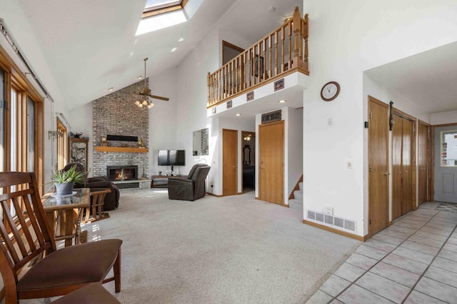 34470 Spruce Ln, Pequot Lakes, MN 56472 - living area with a fireplace, high vaulted ceiling, ceiling fan, stairway, and a skylight