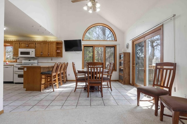 34470 Spruce Ln, Pequot Lakes, MN 56472 - dining room with vaulted ceiling, light tile patterned floors, ceiling fan, light carpet, and baseboards