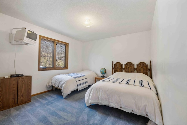 34470 Spruce Ln, Pequot Lakes, MN 56472 - bedroom featuring a wall mounted air conditioner, carpet, a textured ceiling, and baseboards
