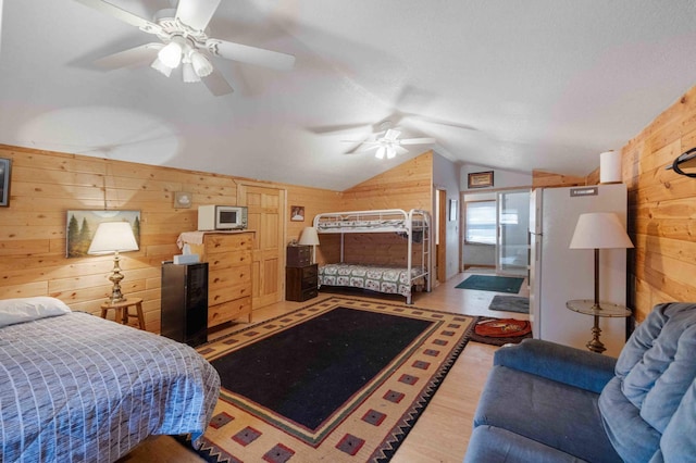 34470 Spruce Ln, Pequot Lakes, MN 56472 - bedroom with wooden walls, lofted ceiling, light wood-style flooring, and ceiling fan