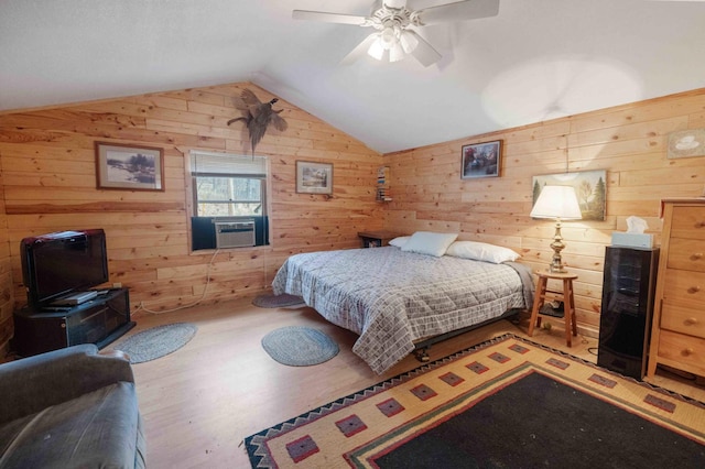 34470 Spruce Ln, Pequot Lakes, MN 56472 - bedroom featuring lofted ceiling, cooling unit, wooden walls, wood finished floors, and ceiling fan