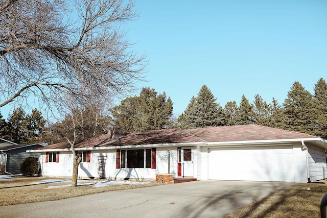 ranch-style house with a garage and driveway