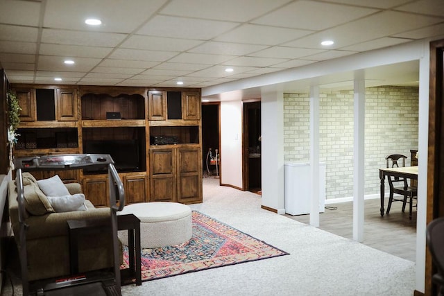 living area featuring recessed lighting, baseboards, light colored carpet, and a drop ceiling
