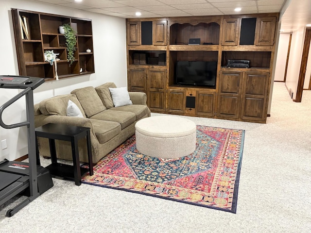 living area featuring carpet floors, recessed lighting, and a drop ceiling