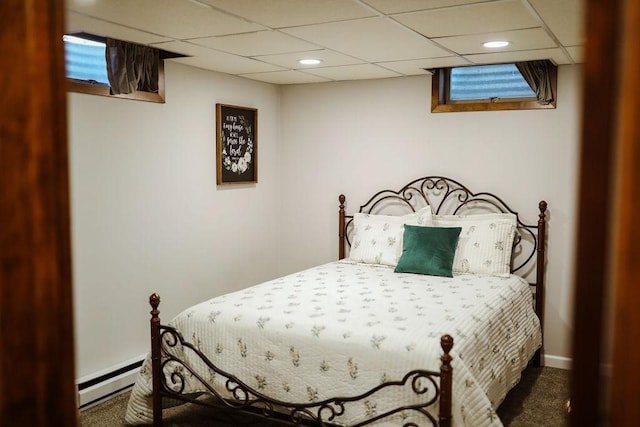 carpeted bedroom featuring recessed lighting, baseboards, a drop ceiling, and a baseboard radiator