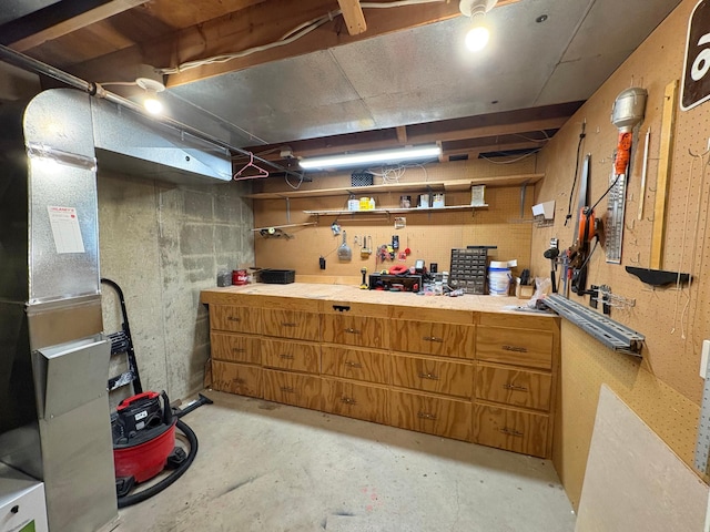 unfinished below grade area featuring a workshop area