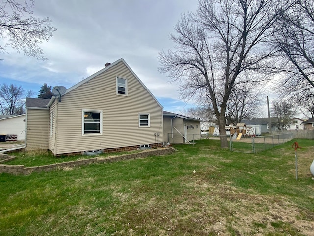 back of property with fence and a yard