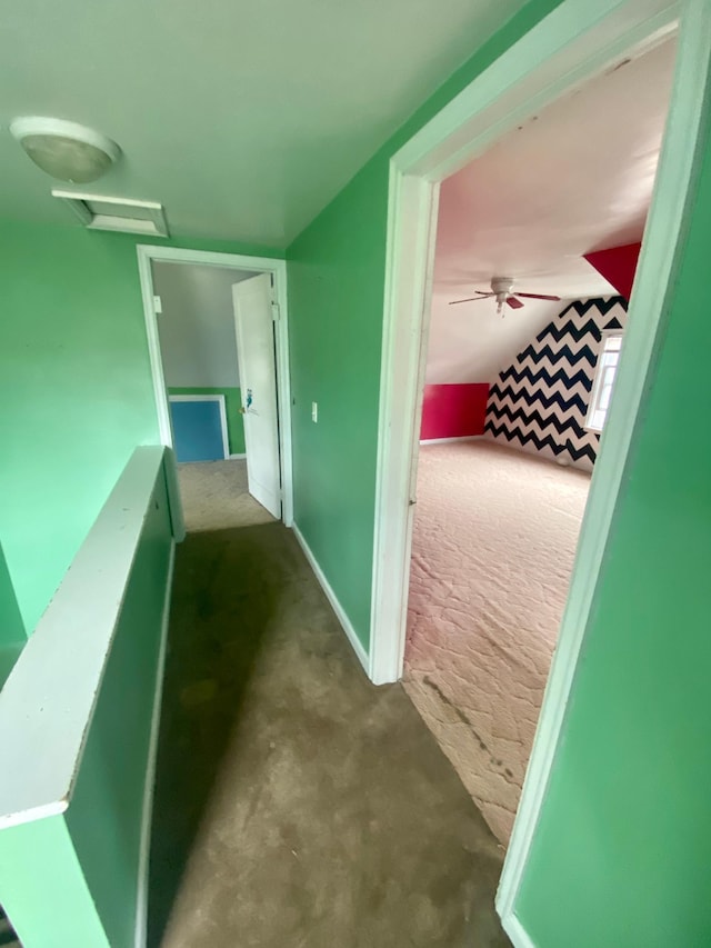 hallway with attic access and carpet