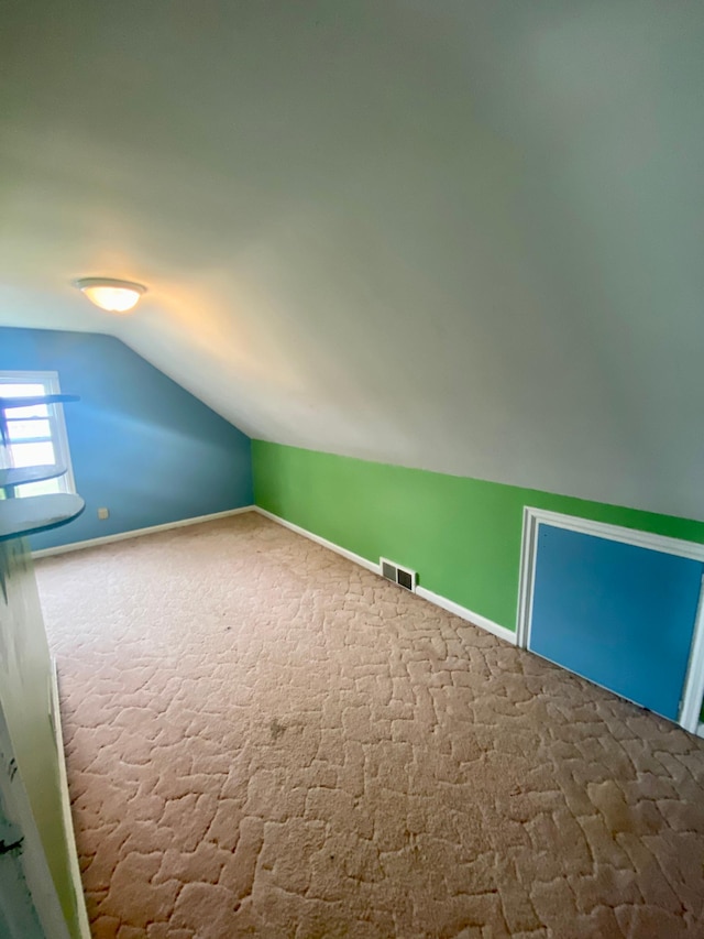 bonus room featuring carpet flooring, visible vents, and lofted ceiling