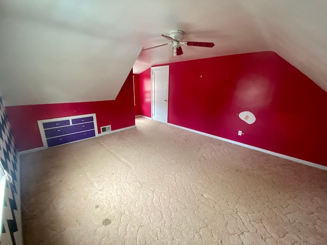 bonus room with carpet floors, ceiling fan, visible vents, baseboards, and lofted ceiling