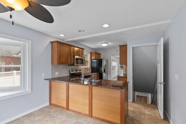 6049 Wentworth Ave, Minneapolis, MN 55419 - kitchen with fridge with ice dispenser, stainless steel microwave, dark stone countertops, a textured ceiling, and brown cabinetry