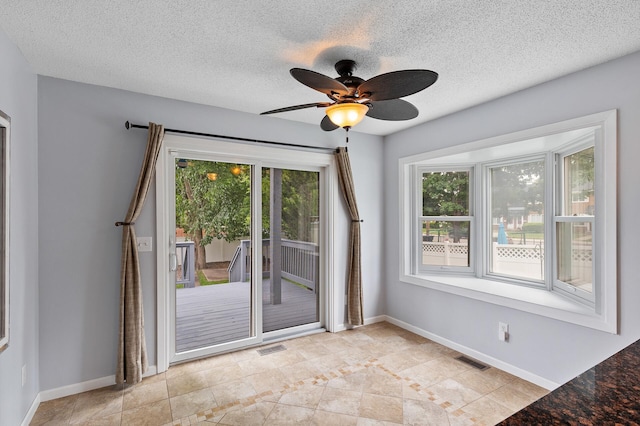 6049 Wentworth Ave, Minneapolis, MN 55419 - spare room featuring healthy amount of natural light, a ceiling fan, a textured ceiling, and light tile patterned floors