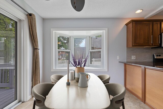6049 Wentworth Ave, Minneapolis, MN 55419 - dining area with a desk, a textured ceiling, light tile patterned floors, and recessed lighting