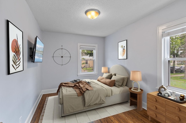 6049 Wentworth Ave, Minneapolis, MN 55419 - bedroom featuring light wood-style flooring, multiple windows, and a textured ceiling
