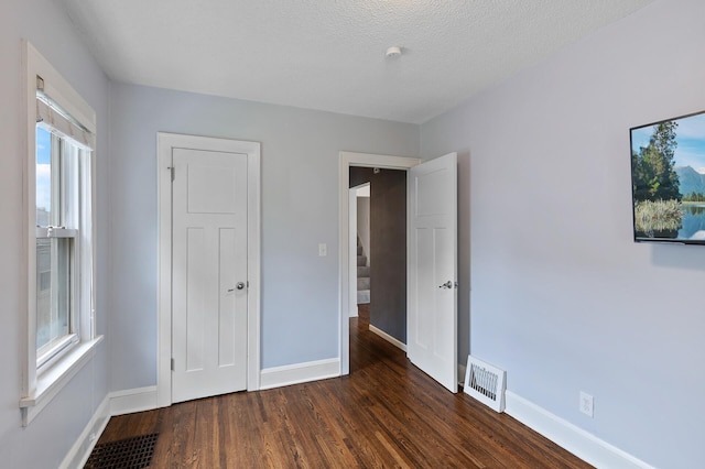 6049 Wentworth Ave, Minneapolis, MN 55419 - unfurnished bedroom with wood finished floors and multiple windows