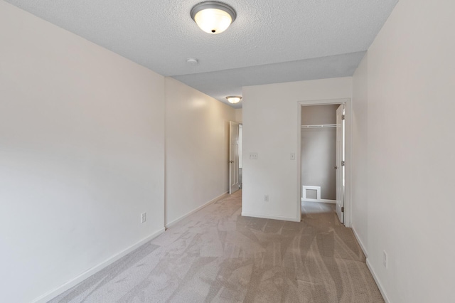 6049 Wentworth Ave, Minneapolis, MN 55419 - unfurnished bedroom featuring carpet flooring, a textured ceiling, a closet, and a walk in closet