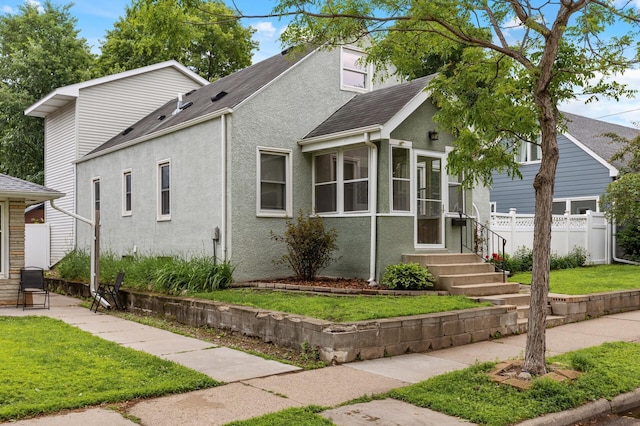 6049 Wentworth Ave, Minneapolis, MN 55419 - bungalow-style house featuring stucco siding, a shingled roof, and a sunroom